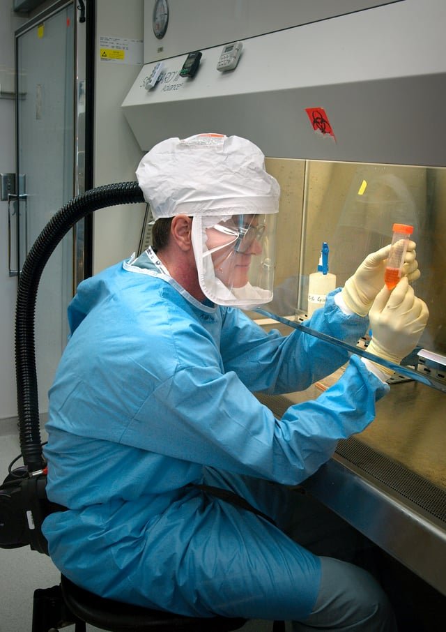 Centers for Disease Control and Prevention as Dr. Terrence Tumpey examines a reconstructed version of the 1918 flu.